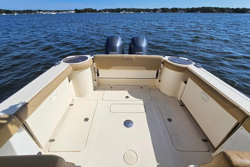 Slide: The Image of 2016 Scout 275 Dorado boat deck with twin engines on a sunny day. - 30