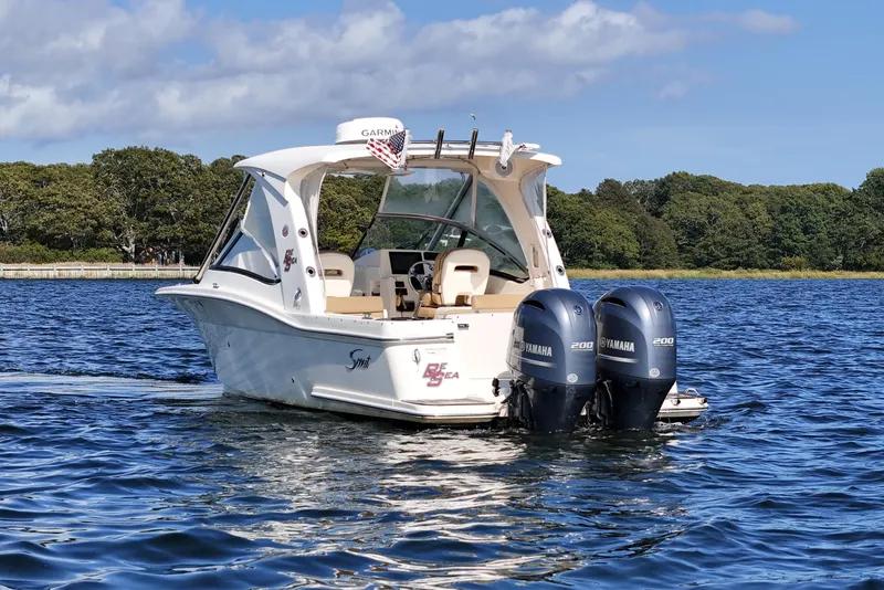Slide: The Image of 2016 Scout 275 Dorado boat with twin Yamaha engines on a sunny day. - 5