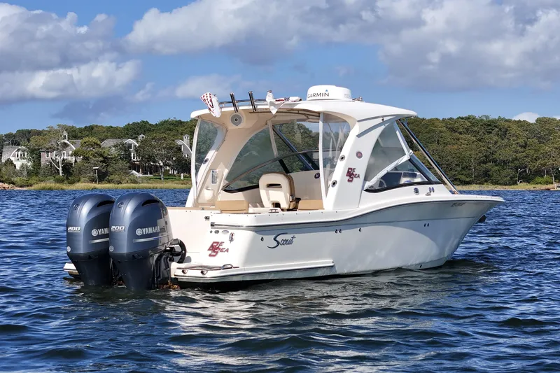 Slide: The Image of 2016 Scout 275 Dorado boat with twin Yamaha engines on a scenic lake. - 7