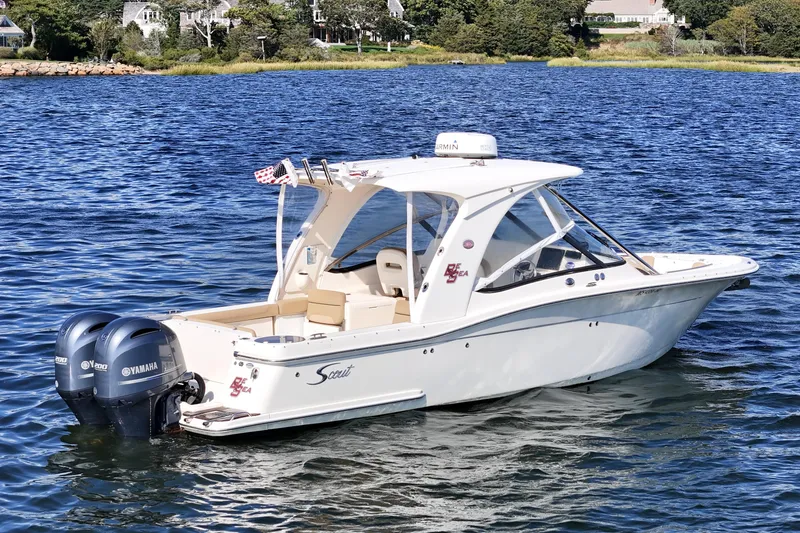 Slide: The Image of 2016 Scout 275 Dorado boat with twin Yamaha engines on a scenic lake. - 8