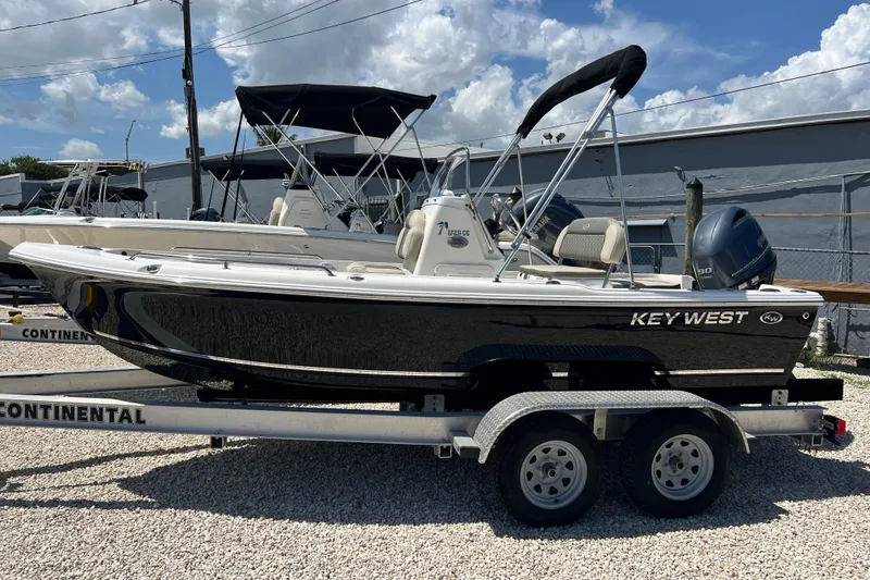 The Image of 2026 Key West 1720 Center Console boat on trailer, parked outdoors. - 1