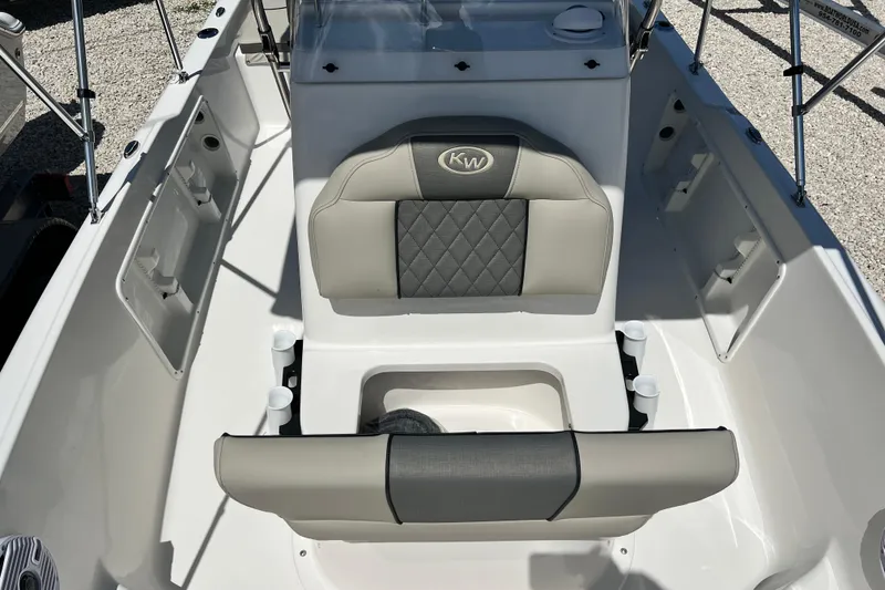 Slide: The Image of 2026 Key West 1720 Center Console boat interior with cushioned seating and storage compartments. - 13