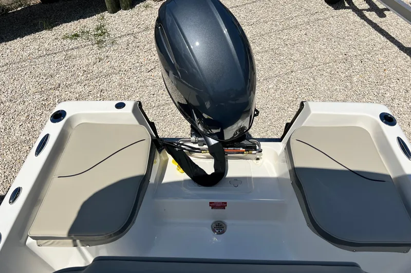 Slide: The Image of 2026 Key West 1720 Center Console boat with outboard motor and cushioned seating. - 14