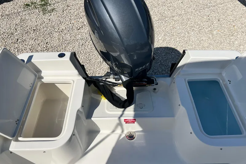 Slide: The Image of 2026 Key West 1720 Center Console boat with outboard motor and storage compartments. - 15