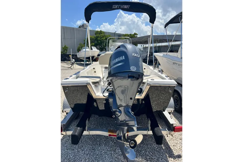 Slide: The Image of 2026 Key West 1720 Center Console boat with Yamaha 90 engine, parked outdoors. - 5