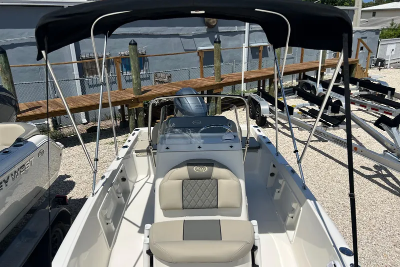 Slide: The Image of 2026 Key West 1720 Center Console boat with canopy, docked on gravel lot. - 7