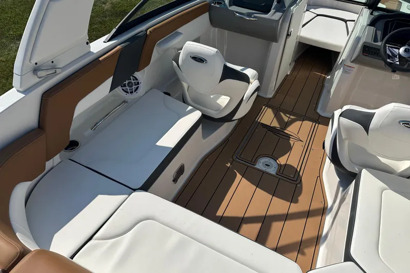 Slide: The Image of 2026 CHAPPARRAL 23 SSi boat interior with white seating and brown flooring. - 11