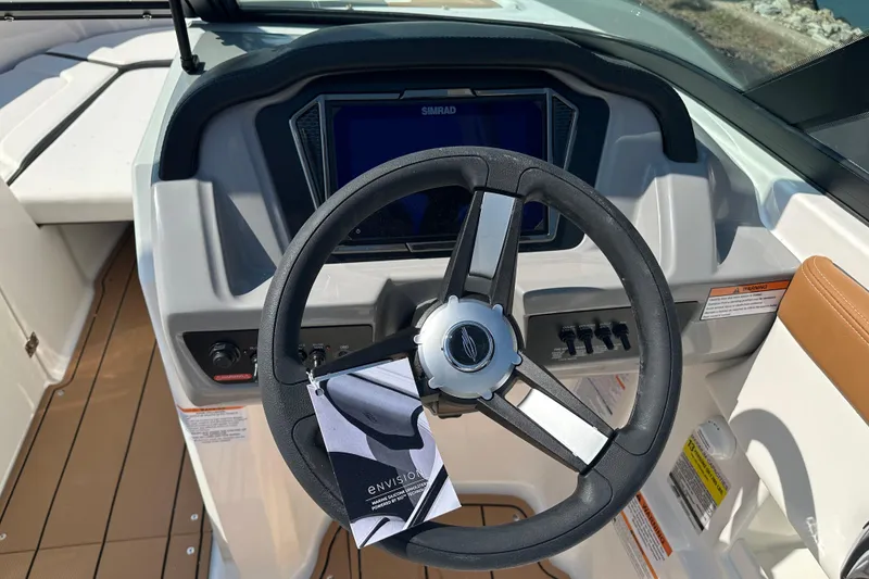 Slide: The Image of Steering wheel of 2026 CHAPPARRAL 23 SSi boat with dashboard controls. - 13