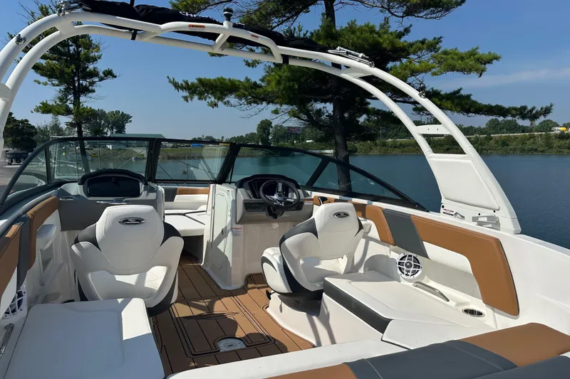 Slide: The Image of 2026 CHAPPARRAL 23 SSi boat interior with white seating, on a calm lake. - 8