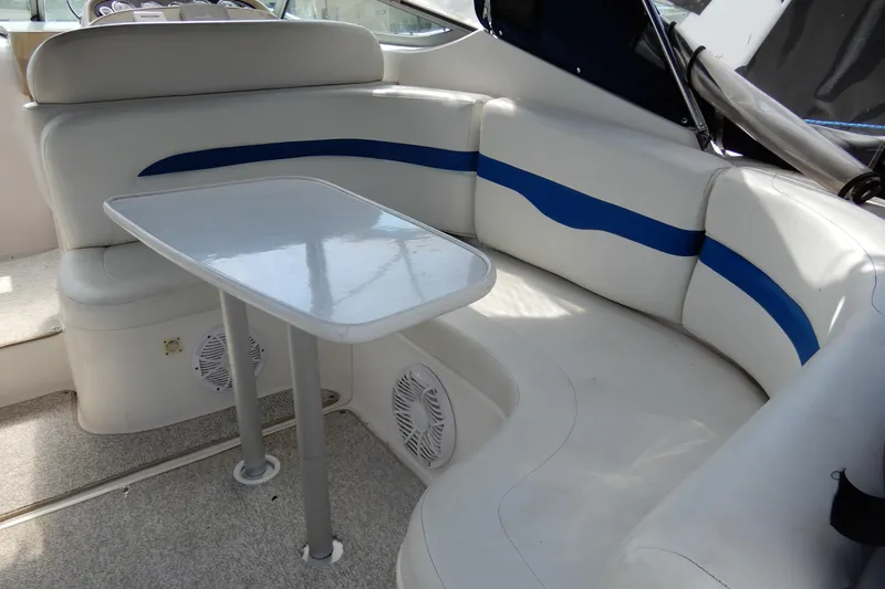 Slide: The Image of 2002 Chaparral Signature 320 boat interior with white seating and blue accents. - 11