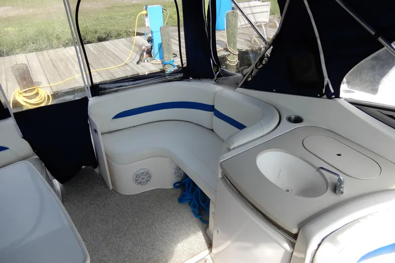 Slide: The Image of 2002 Chaparral Signature 320 boat interior with seating and sink area. - 12