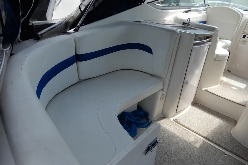 Slide: The Image of 2002 Chaparral Signature 320 boat interior with white seating and compact kitchenette. - 13