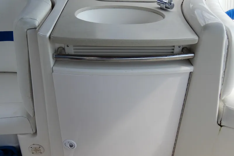 Slide: The Image of 2002 Chaparral Signature 320 boat interior with sink and storage compartment. - 14