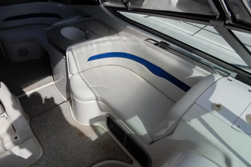 Slide: The Image of 2002 Chaparral Signature 320 boat interior with white seating and a small sink. - 17