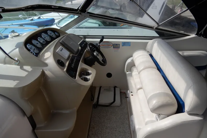 Slide: The Image of 2002 Chaparral Signature 320 boat interior with steering console and seating area. - 19
