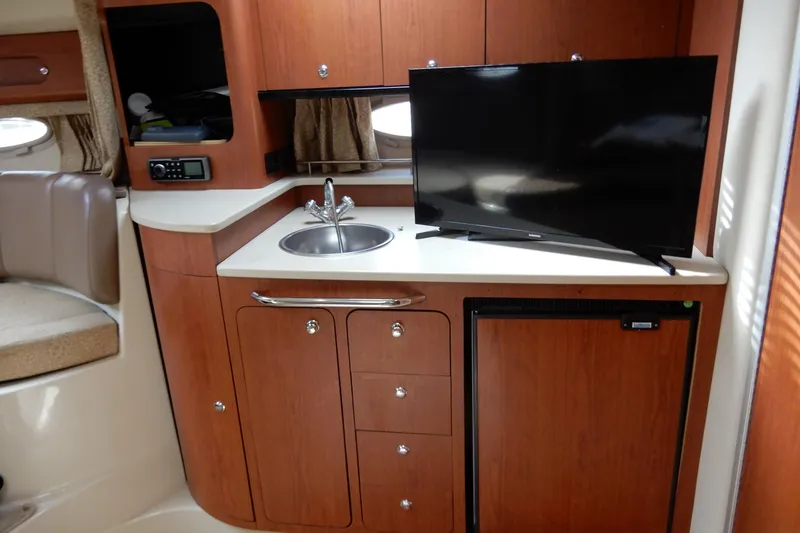 Slide: The Image of 2002 Chaparral Signature 320 interior with kitchenette, sink, TV, and mini-fridge. - 30