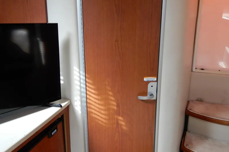 Slide: The Image of Interior of 2002 Chaparral Signature 320 with wooden door and TV. - 31