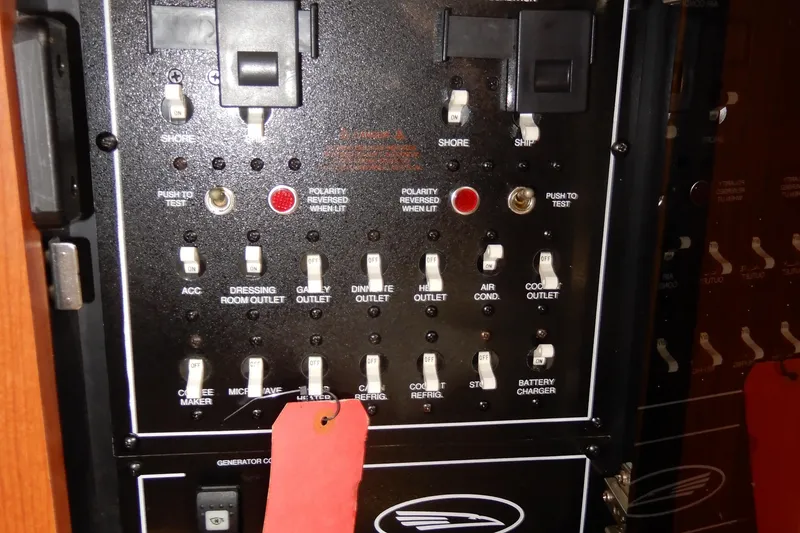 Slide: The Image of Electrical control panel on a 2002 Chaparral Signature 320 boat with various switches and indicators. - 38