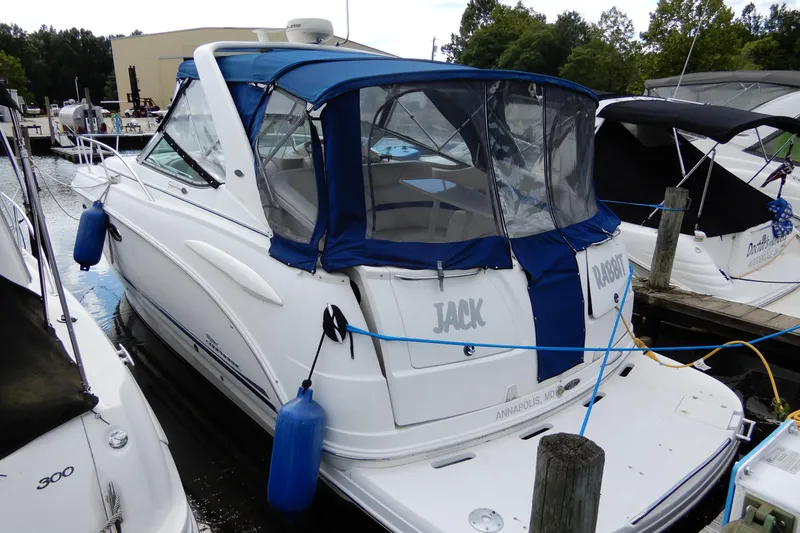 Slide: The Image of 2002 Chaparral Signature 320 boat docked with blue canopy and fenders. - 4