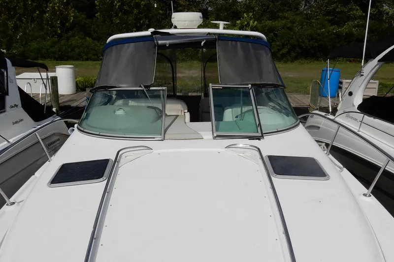 Slide: The Image of 2002 Chaparral Signature 320 boat docked, featuring sleek design and spacious deck area. - 5