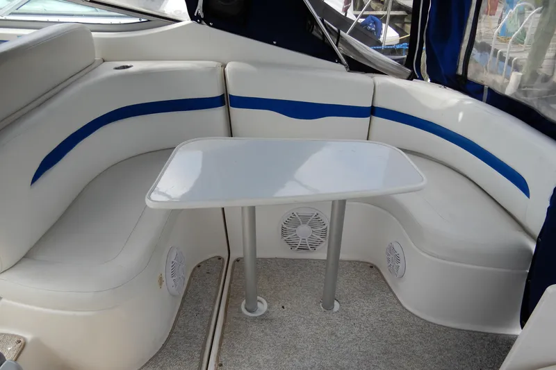 Slide: The Image of 2002 Chaparral Signature 320 boat interior with white seating and table. - 9