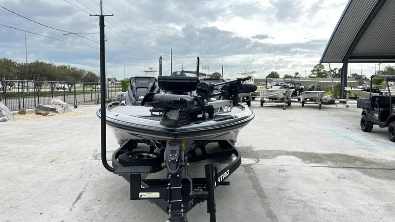 Slide: The Image of 2021 Nitro Z21 boat parked outdoors on a concrete lot under cloudy skies. - 1