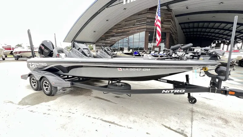 Slide: The Image of 2021 Nitro Z21 boat on trailer outside a modern showroom. - 10