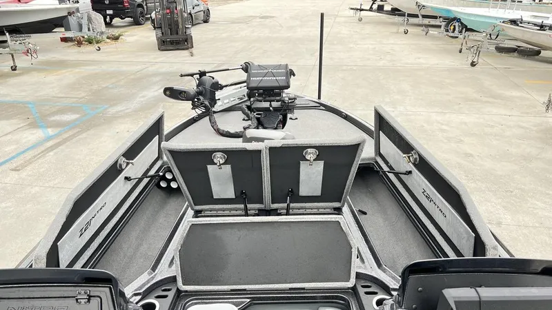 Slide: The Image of 2021 Nitro Z21 boat interior with storage compartments and fishing equipment. - 11