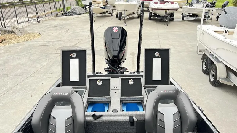 Slide: The Image of 2021 Nitro Z21 boat interior with seats, storage compartments, and outboard motor. - 14