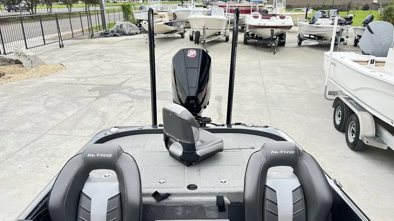 Slide: The Image of 2021 Nitro Z21 boat with dual seats and motor, parked among other boats. - 17