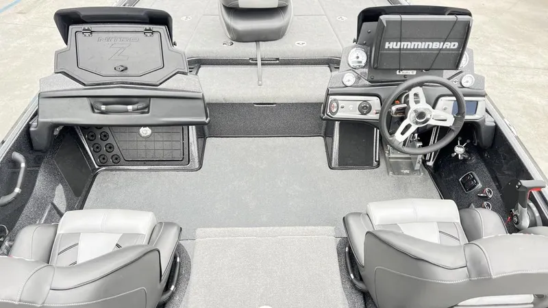 Slide: The Image of 2021 Nitro Z21 boat interior with steering wheel, seats, and Humminbird electronics. - 2