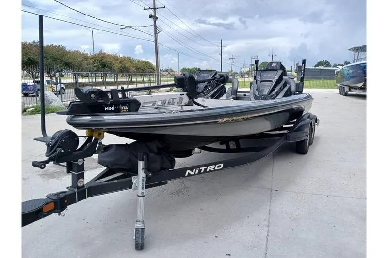 Slide: The Image of 2021 Nitro Z21 boat on trailer, parked outdoors under cloudy sky. - 20