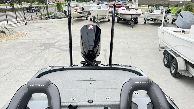 Slide: The Image of 2021 Nitro Z21 boat with dual seats and motor, parked among other boats. - 8