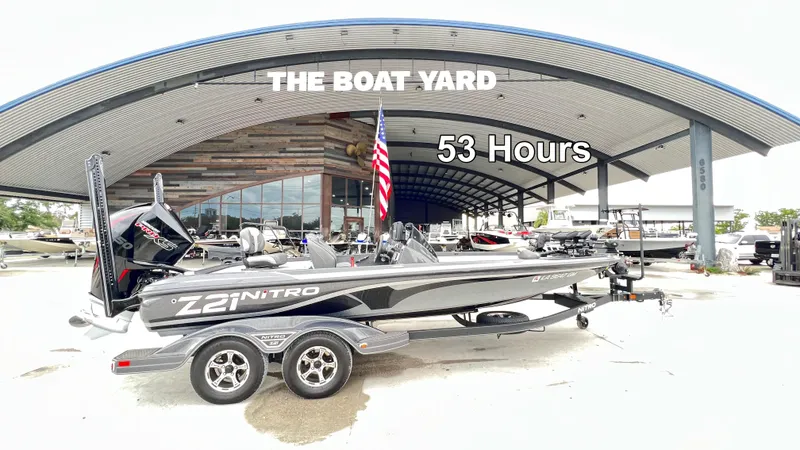 Slide: The Image of 2021 Nitro Z21 boat at The Boat Yard, 53 hours used, parked under a large canopy. - 9