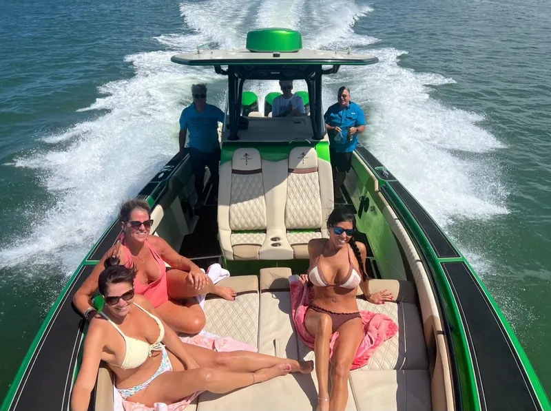 Slide: The Image of People relaxing on a 2018 Statement 380 Open boat cruising on the water. - 3