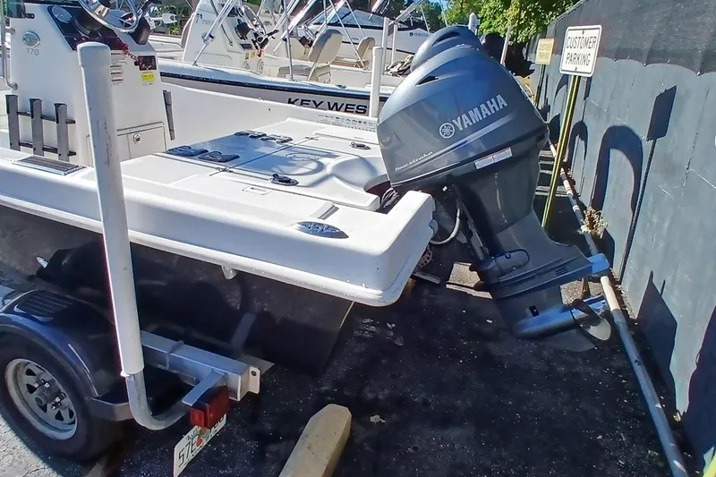 Slide: The Image of 2015 Starcraft 170 boat with Yamaha outboard motor in parking area. - 4