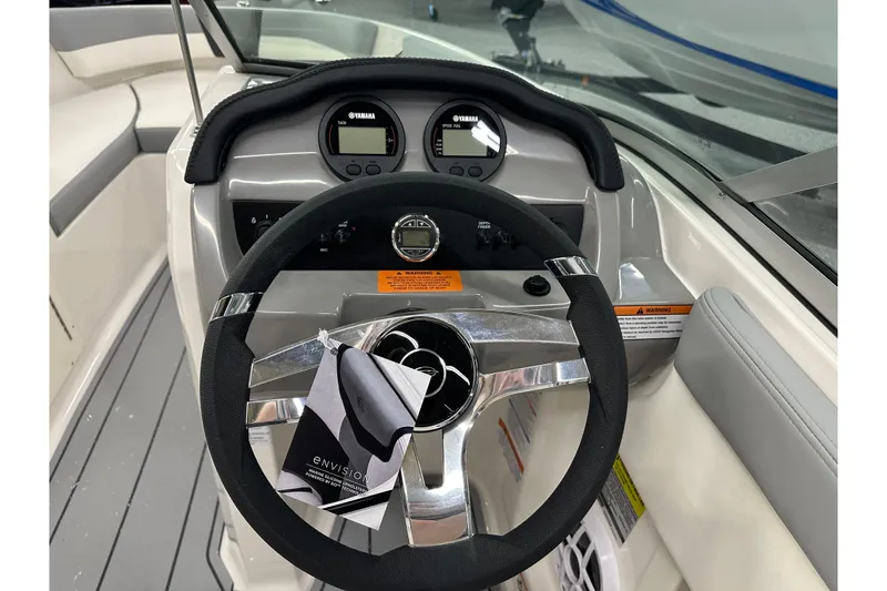 Slide: The Image of Steering wheel and dashboard of 2026 Chaparral 21 SSi boat, featuring Yamaha gauges. - 11