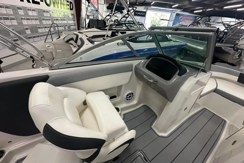 Slide: The Image of 2026 Chaparral 21 SSi boat interior with white seating and modern dashboard. - 12