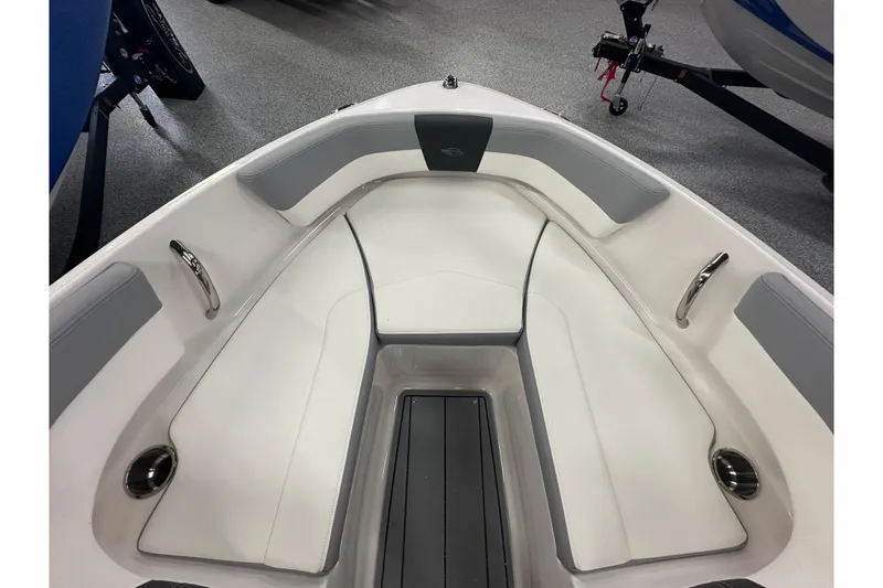 Slide: The Image of 2026 Chaparral 21 SSi boat interior with white and gray seating, sleek design. - 14