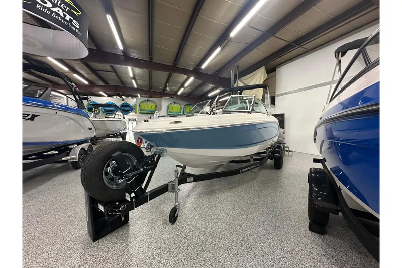 Slide: The Image of 2026 Chaparral 21 SSi boat displayed in showroom, featuring sleek design and modern features. - 4