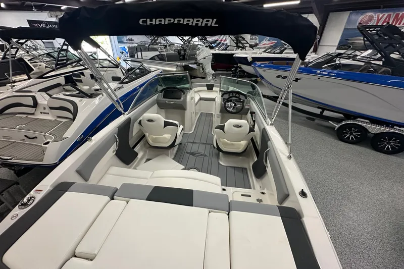 Slide: The Image of 2026 Chaparral 21 SSi boat interior with seating and steering wheel in showroom. - 7