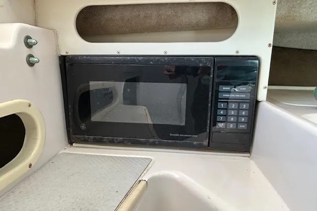 Slide: The Image of 1999 Grady-White Sailfish 272 interior with built-in microwave oven. - 10