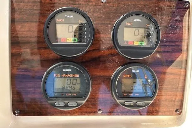 Slide: The Image of Yamaha gauges on 1999 Grady-White Sailfish 272 boat dashboard, displaying tachometer and fuel management. - 11