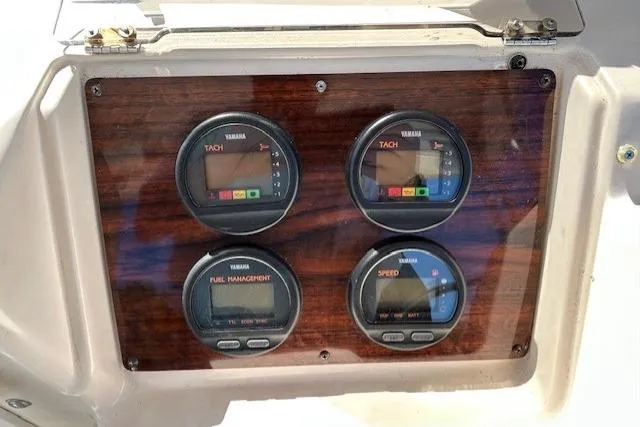 Slide: The Image of 1999 Grady-White Sailfish 272 dashboard with Yamaha gauges for tachometer, fuel, and speed. - 14