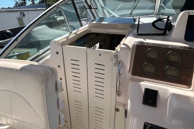 Slide: The Image of 1999 Grady-White Sailfish 272 boat interior with control panel and cabin door. - 15