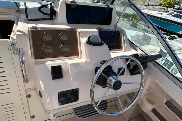 Slide: The Image of 1999 Grady-White Sailfish 272 helm with steering wheel and instrument panel. - 16
