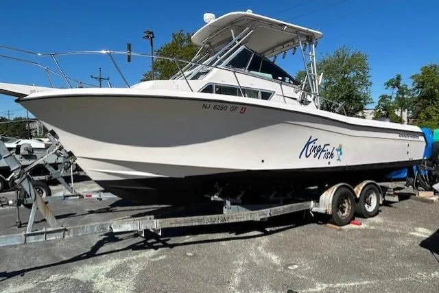 Slide: The Image of 1999 Grady-White Sailfish 272 boat on trailer, labeled "King Fish," parked outdoors. - 2