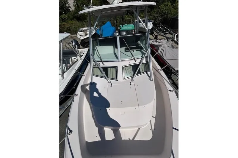 Slide: The Image of 1999 Grady-White Sailfish 272 boat, top view, docked with visible cabin and deck. - 21