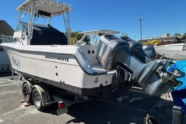 Slide: The Image of 1999 Grady-White Sailfish 272 boat with dual Yamaha engines on a trailer. - 3