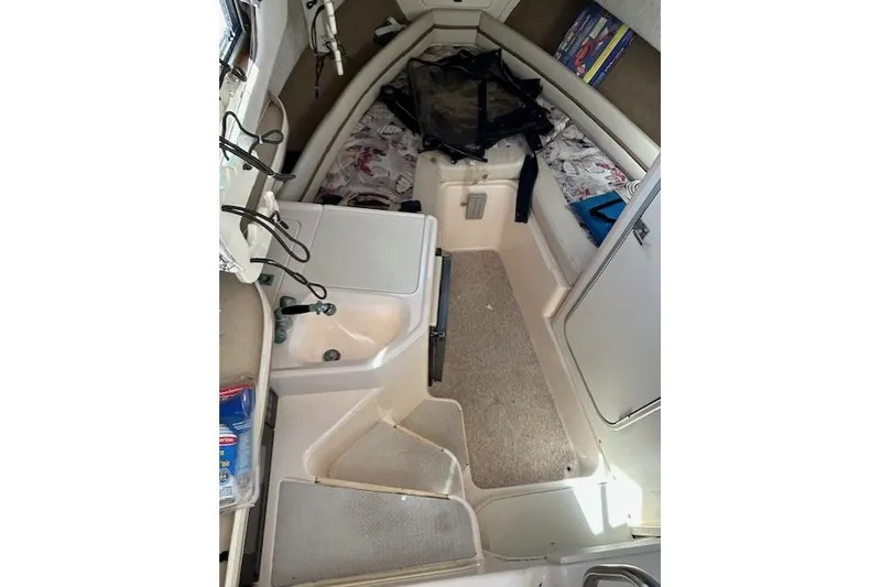 Slide: The Image of 1999 Grady-White Sailfish 272 cabin interior with sink, storage, and seating area. - 5